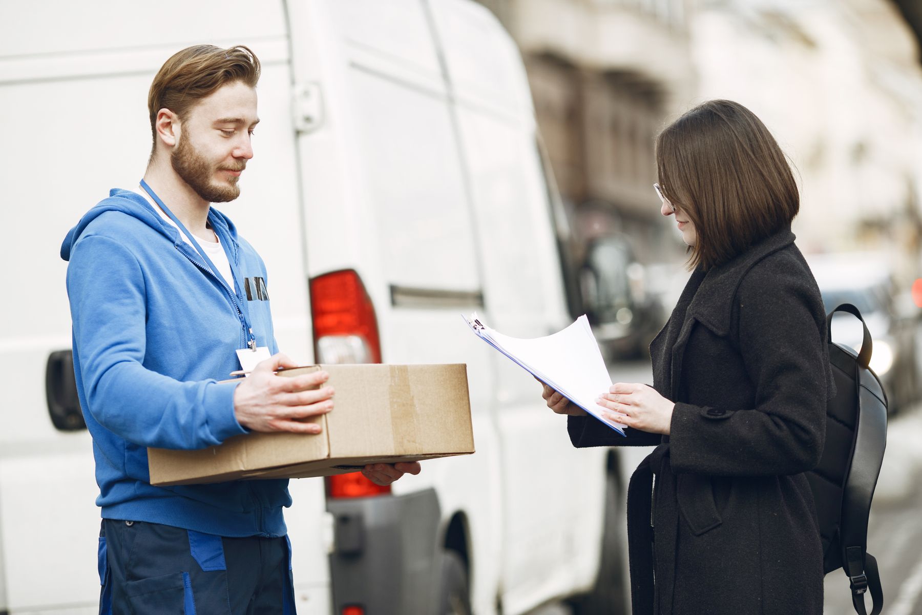 A courier handing a package to a customer