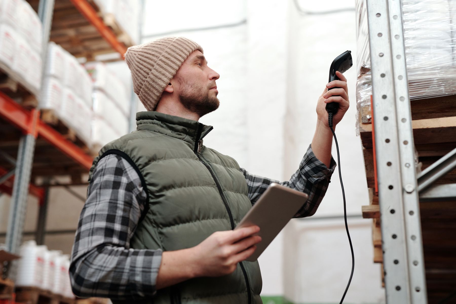 A warehouse associate scanning inventory with a handheld device