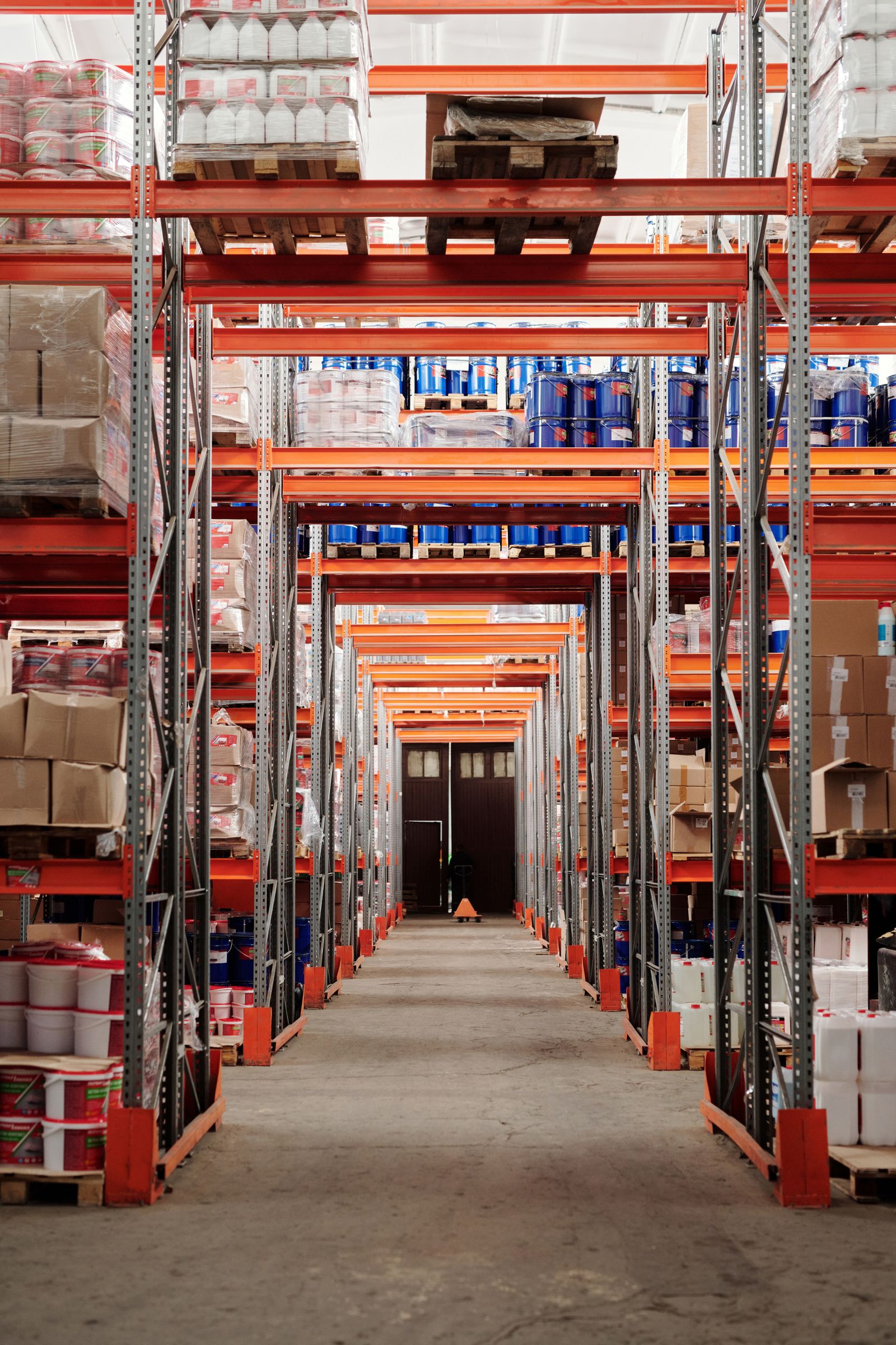 Palletized inventory on racks in a warehouse aisle